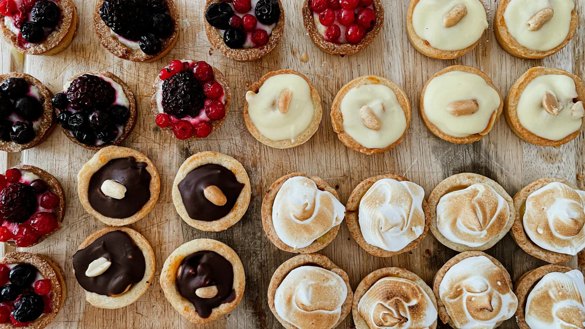 Mini tarts lined up on a board